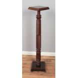 A carved mahogany Torchere plant/ornament stand. Approx. height 126cm.