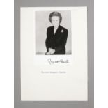 A signed autographed photo of former Prime Minister Margaret Thatcher mounted on A4 paper labelled