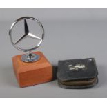 A mounted Mercedes three point star mascot along with pocket tool kit in leather zip case.