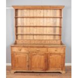 A large pine farmhouse welsh dresser with three drawers over three doors. Hx216cm Wx175cm Dx60cm