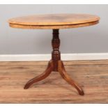 A walnut topped window table, on turned oak column and tripod base, with inlay decoration.