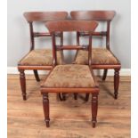 Three Victorian mahogany dining chairs featuring floral upholstered seats.