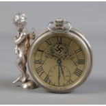 An early 20th century white metal clock bearing Swastika to face and decorative cherub to side.