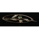 A 9ct gold peridot and seed pearl brooch. Total weight 2g.