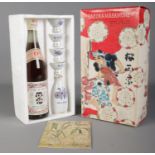 Sakura-Masamune; a cased set, to include sealed 720ml bottle, sake server and four cups.