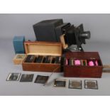 A Newton & Co magic lantern, converted to electric, along with spare bulb and three boxes of