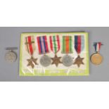 A collection of WWII medals to include Africa Star, The Defence Medal, 1939-1945 Star, etc.