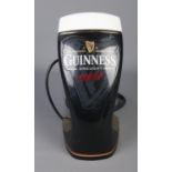 A Guinness bar top pump header light.