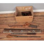 A box of assorted vintage tools including J. Wilkinson carriage screwdriver, sharpening stone,
