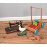 A collection of assorted items to include cast iron goose doorstop, children's wooden toy, antique