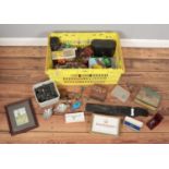 A box of collectables. Includes diecast vehicles, novelty figures, cased Miranda binoculars, tins,