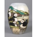 A Moorcroft pottery 'Puffin' baluster shaped vase, designed by Carol Lovett. Stamped to base, with