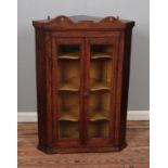 An oak corner cabinet with double glazed doors and painted interior. Hx108cm Wx74cm