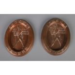 Two copper Johnnie Walker ashtrays.