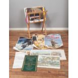 A wooden display stand housing collection of assorted posters and prints to include The Telegraph