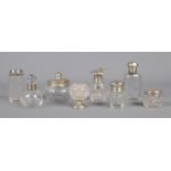 A collection of silver topped and footed glass vessels. To include 'Pumpkin topped' nail varnish