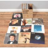 A collection of assorted vinyl records of mainly pop and easy listening. Examples include Genesis,