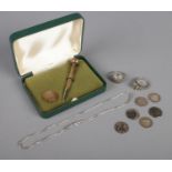 A small quantity of silver. Includes rings, propelling pencil, coins and chain.