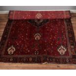 A large wool ground rug featuring floral design and fringe detailing. 280cm x 174cm.