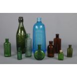 A collection of vintage glass bottles, including W.C. Simpson & Co. Pudsey, Boots, Benbow's Dog