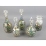 A collection of marbles in glass bottles/decanters.