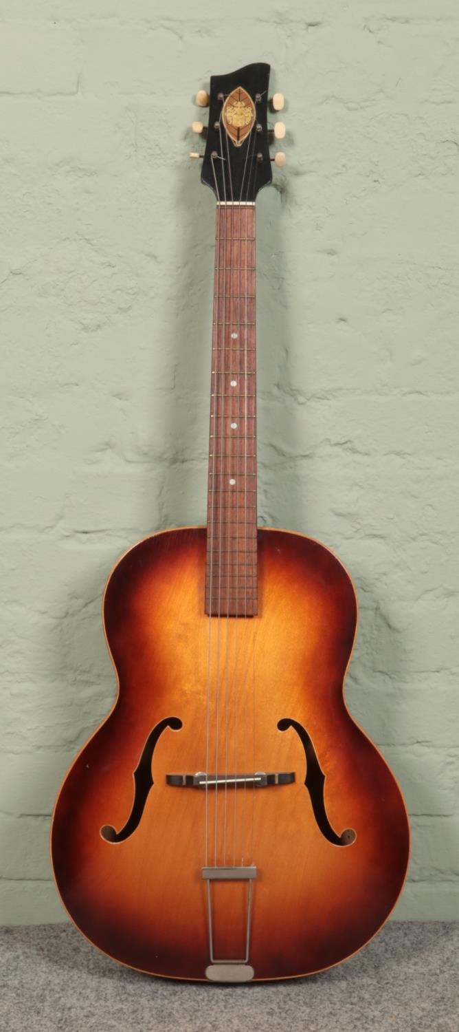 A six string acoustic guitar; unbranded.