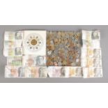 A collection of world banknotes and coins, to include Slovenian, Portuguese, Spanish and GB