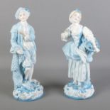 Two Charles Levy Co. blue and white painted porcelain figures depicting a fruit carrier and a