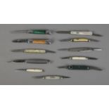 A collection of single and multi-bladed fruit knives including several mother of pearl examples.