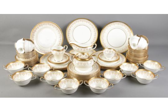 A large quantity of Aynsley 'Gold Dowery' dinnerwares. Includes dinnerplates, sauceboats, cups &