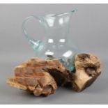 A molten glass jug contained within a driftwood root sculpture. Height: 25cm.