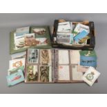 A large box and two albums of vintage postcards including military and aviation subjects.