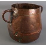 A large twin handled copper pot. (29cm x 40cm)