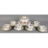 A quantity of 1830-1842 Rockingham teawares. Includes cups & saucers, lidded sugar bowl, etc. Some