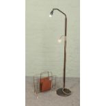 A former gas floor lamp converted to electric along with yellow metal magazine rack.