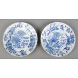 A pair of Chinese Kangxi blue and white dishes decorated in underglaze blue with flowers. Bearing