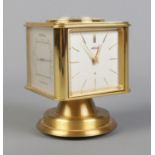 A vintage brass Angelus desk clock/weather station. Having rotating cube shaped body with alarm