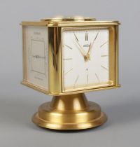 A vintage brass Angelus desk clock/weather station. Having rotating cube shaped body with alarm