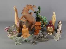 A quantity of oriental figures including large wooden dragon, various buddha examples and