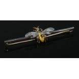A 15ct gold and platinum bar brooch surmounted with a wasp, having enamelled decoration and