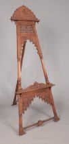 A large easel with extensively carved floral decoration. Height 180cm.