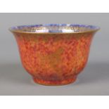 A Wedgwood Lustre miniature bowl by Daisy Makeig Jones, decorated with motifs. Having mottled orange