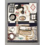 A hinged cutlery box containing an assortment of costume jewellery, including cased buttons,