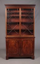 A large Victorian mahogany bookcase with astragal glazed top over cupboard base. Height 216cm, Width