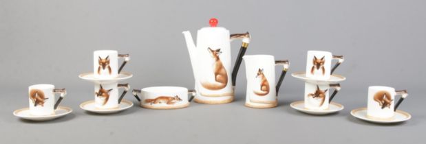 A Royal Doulton bone china coffee set decorated in the Reynard The Fox design, H4927.