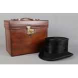 A Victorian brown leather hat case containing a Kirsop & Son top hat. Case monogrammed RHC and