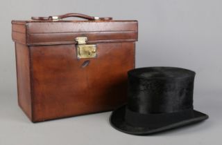 A Victorian brown leather hat case containing a Kirsop & Son top hat. Case monogrammed RHC and