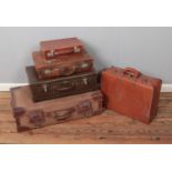 A selection of five vintage suitcases including a Superslat example.