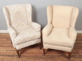 Two upholstered wingback armchairs.