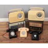 A quantity of vintage radios including Bush example along with three bakelite telephones.